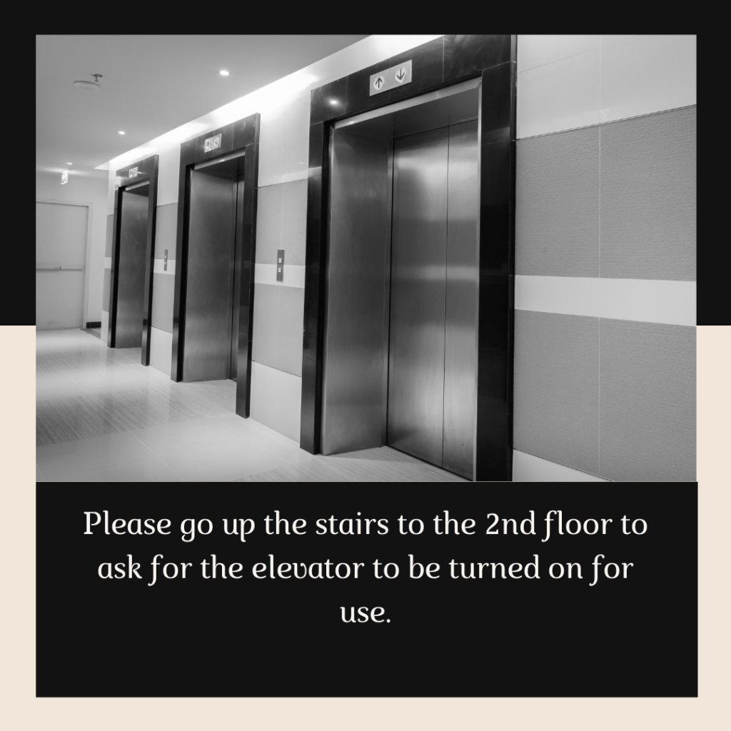 Image of elevators that says "Please go up to the second floor to ask for the elevator to be turned on for use."